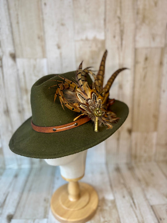 Pheasant feather hat pin with cartridge end and shell casing.