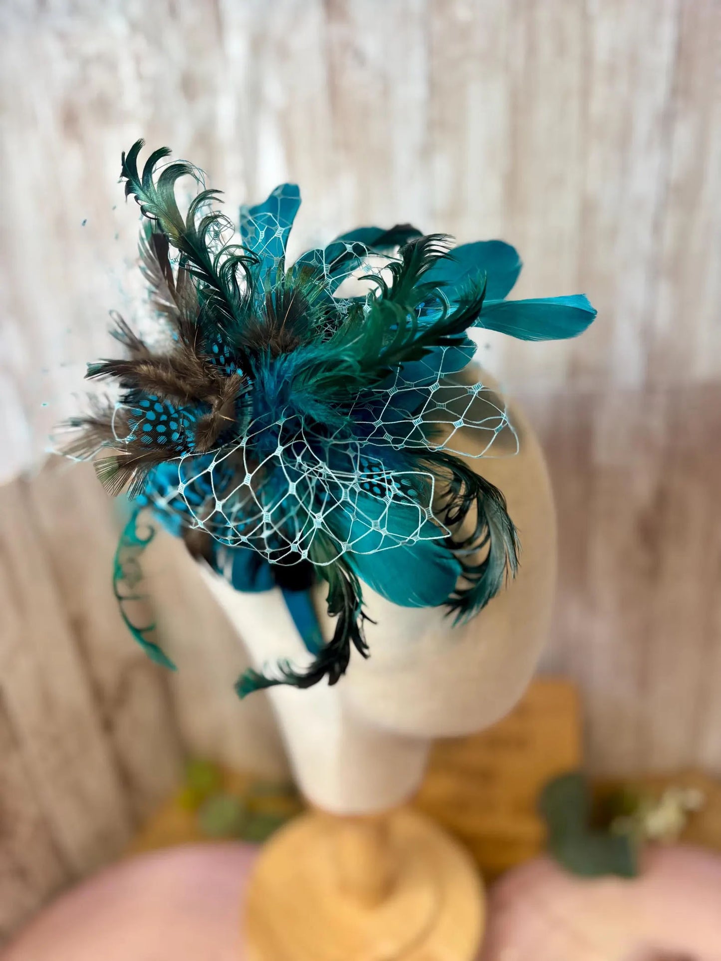 Uniquely designed pheasant feather and sinamay fascinator.
