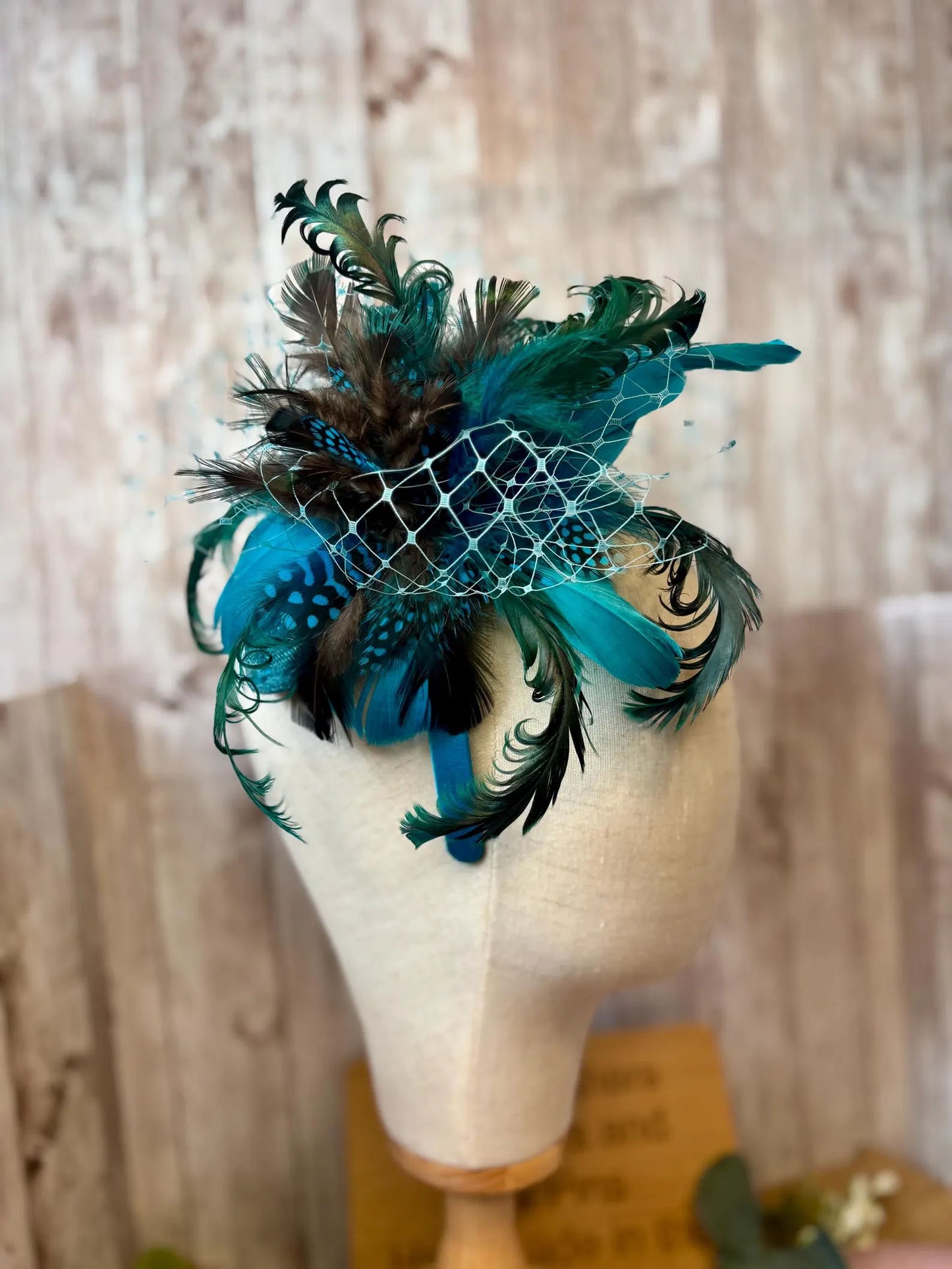 Uniquely designed pheasant feather and sinamay fascinator.