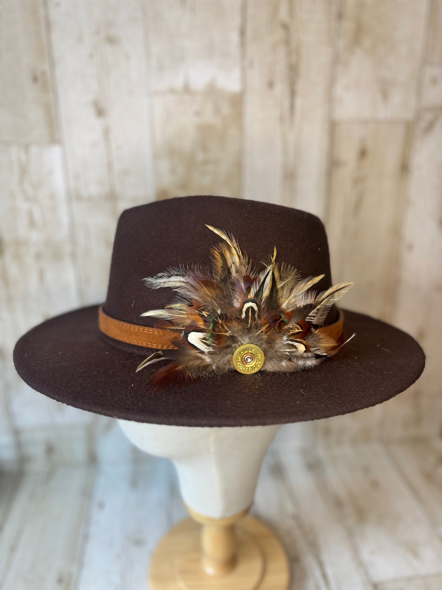 Pheasant feather hat pin with cartridge end.