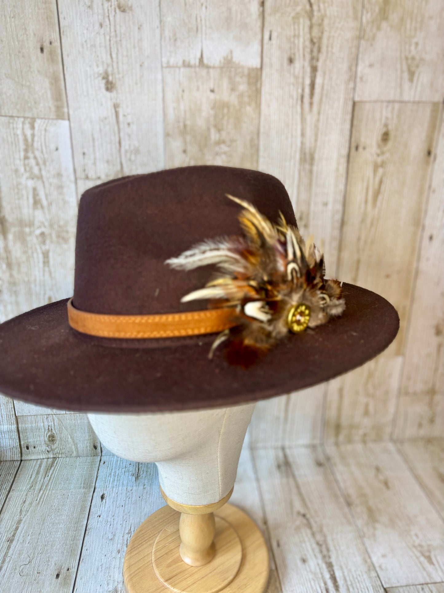 Pheasant feather hat pin with cartridge end.