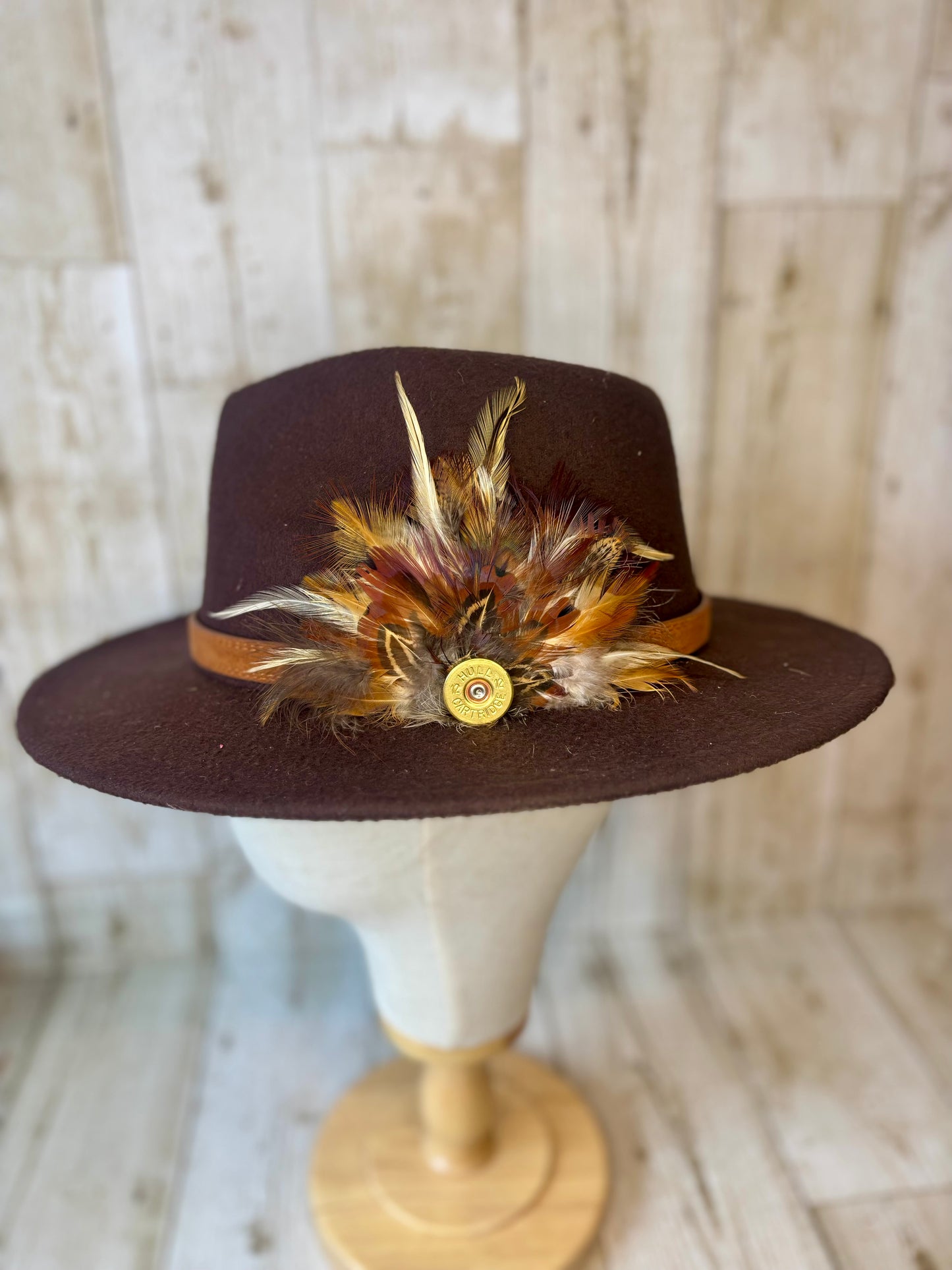 Pheasant feather hat pin with cartridge end.