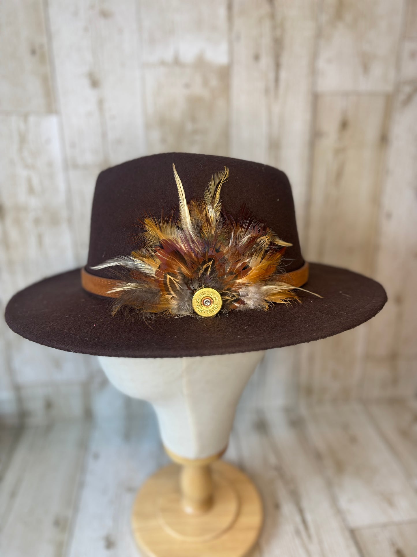Pheasant feather hat pin with cartridge end.