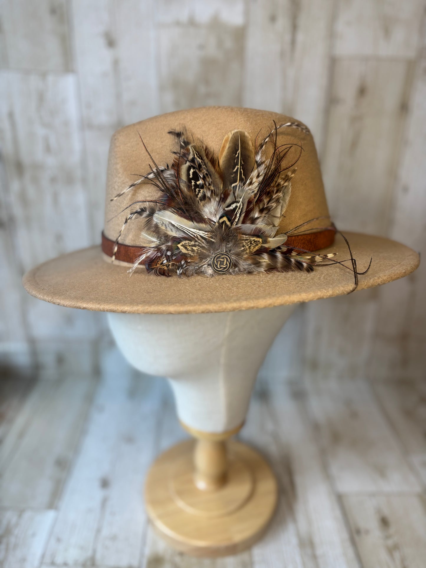 Pheasant feather hat pin with Celtic button.