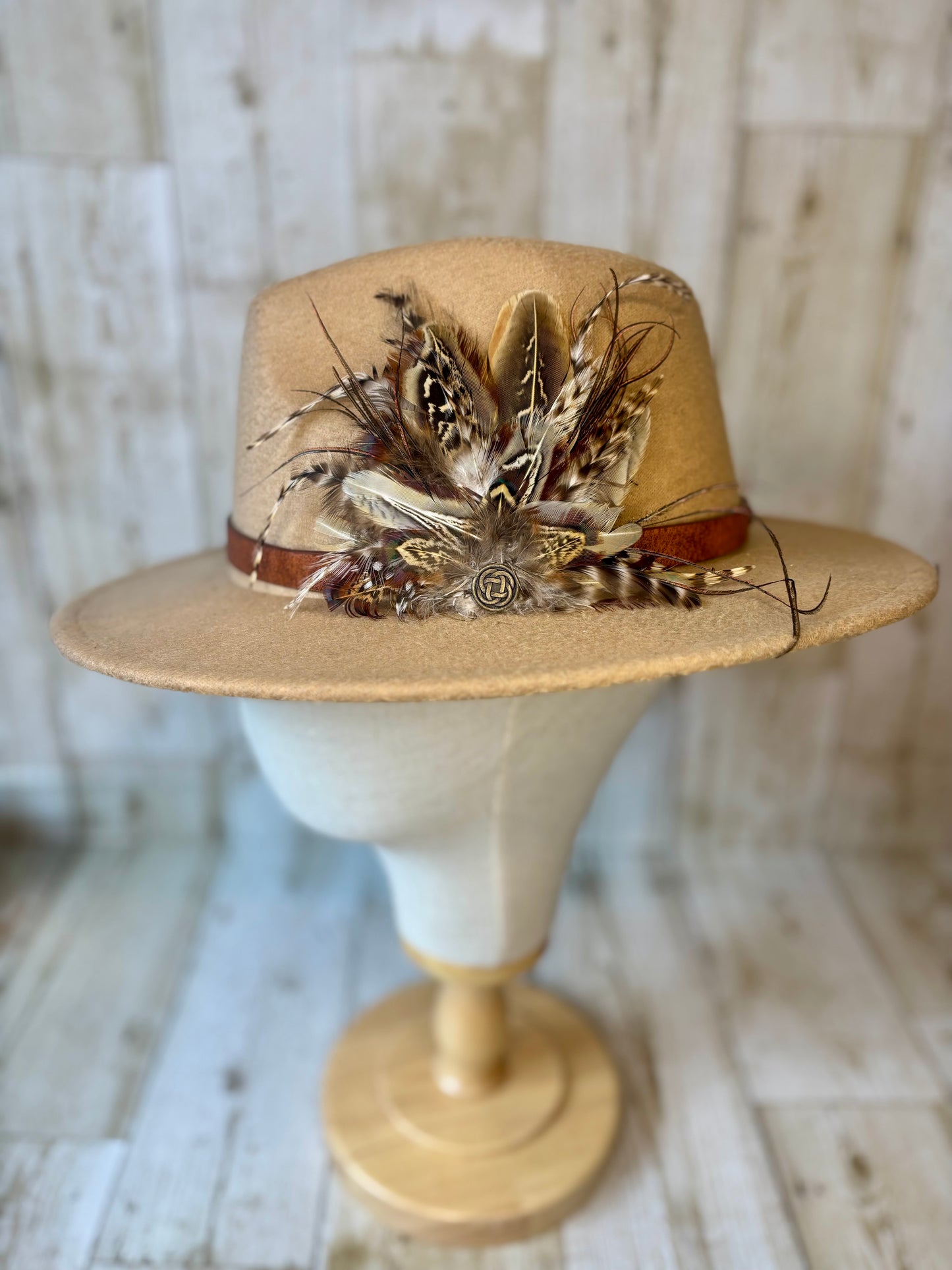 Pheasant feather hat pin with Celtic button.