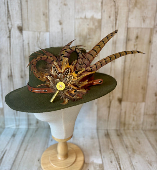 Pheasant feather hat pin with cartridge end and shell casing.