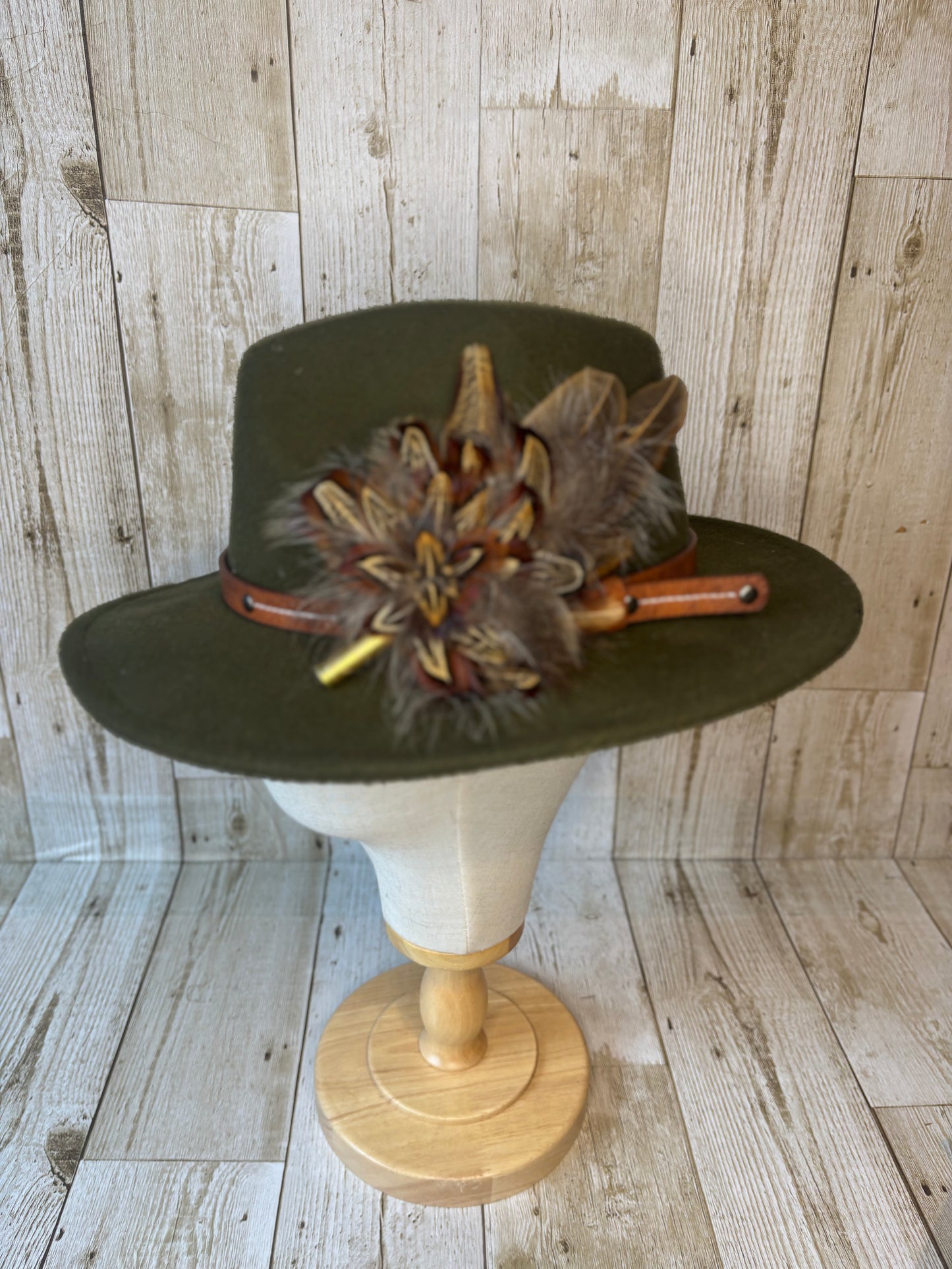 Pheasant feather hat pin with brass casing.