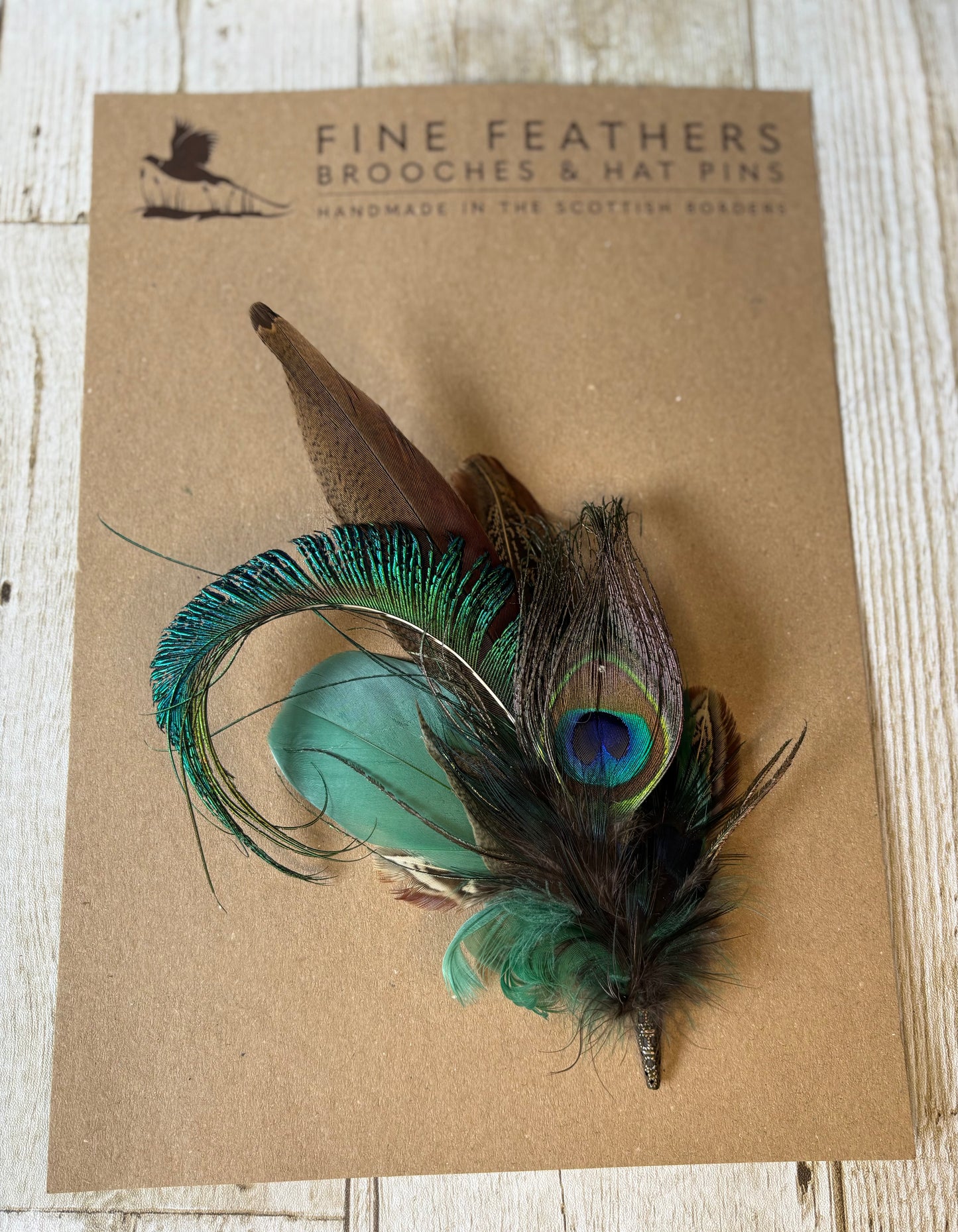 Pheasant feather and peacock feather pin.